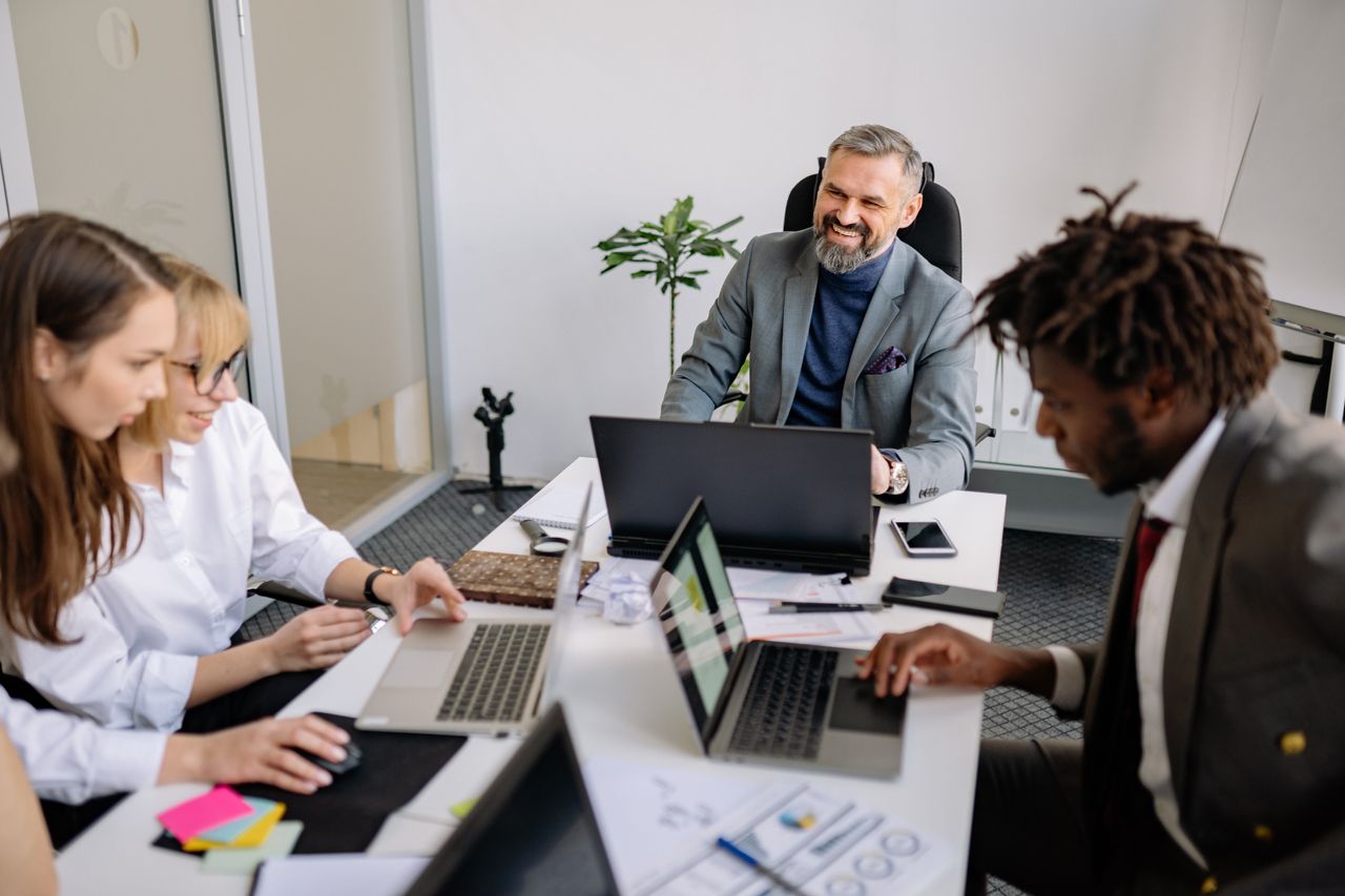 Crafting Captivating Headlines: Your awesome post title goes here A diverse team of professionals engaged in a collaborative meeting in a modern office setting.